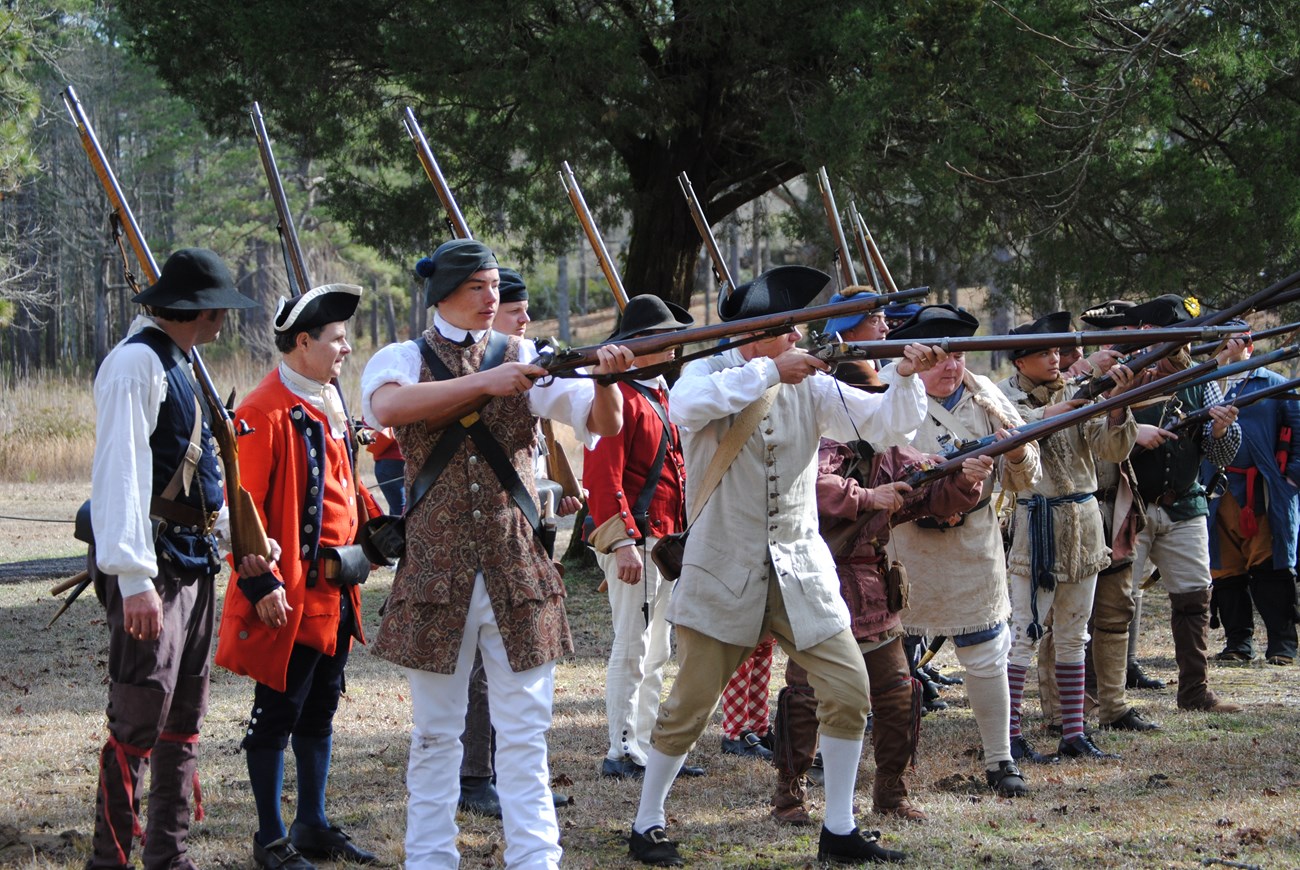 Line of Minutemen preparing to fire