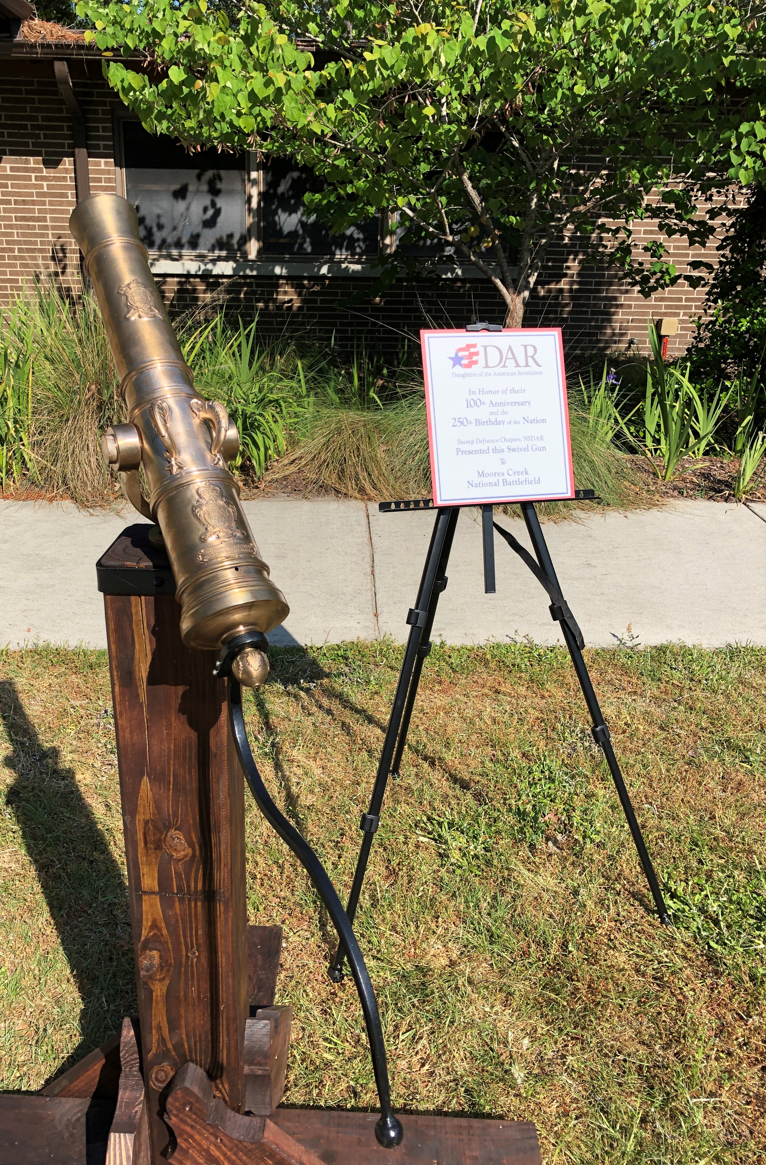 Small bronze cannon with sign