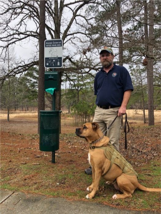 Man holding a dog by a leash