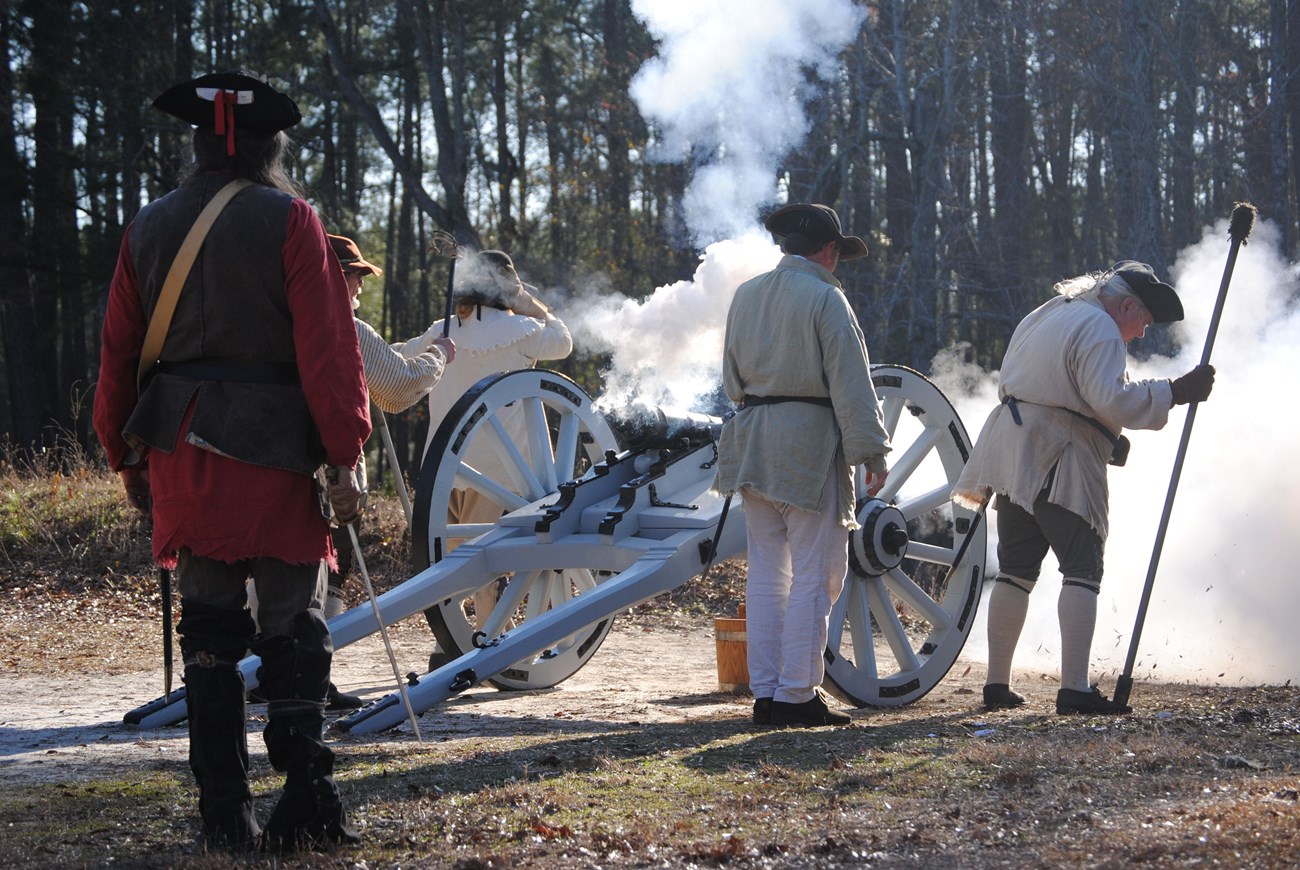 Men firing a cannon