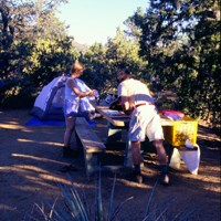 Campers with tent in the unburned section shady section of the Mid Hills Campground.
