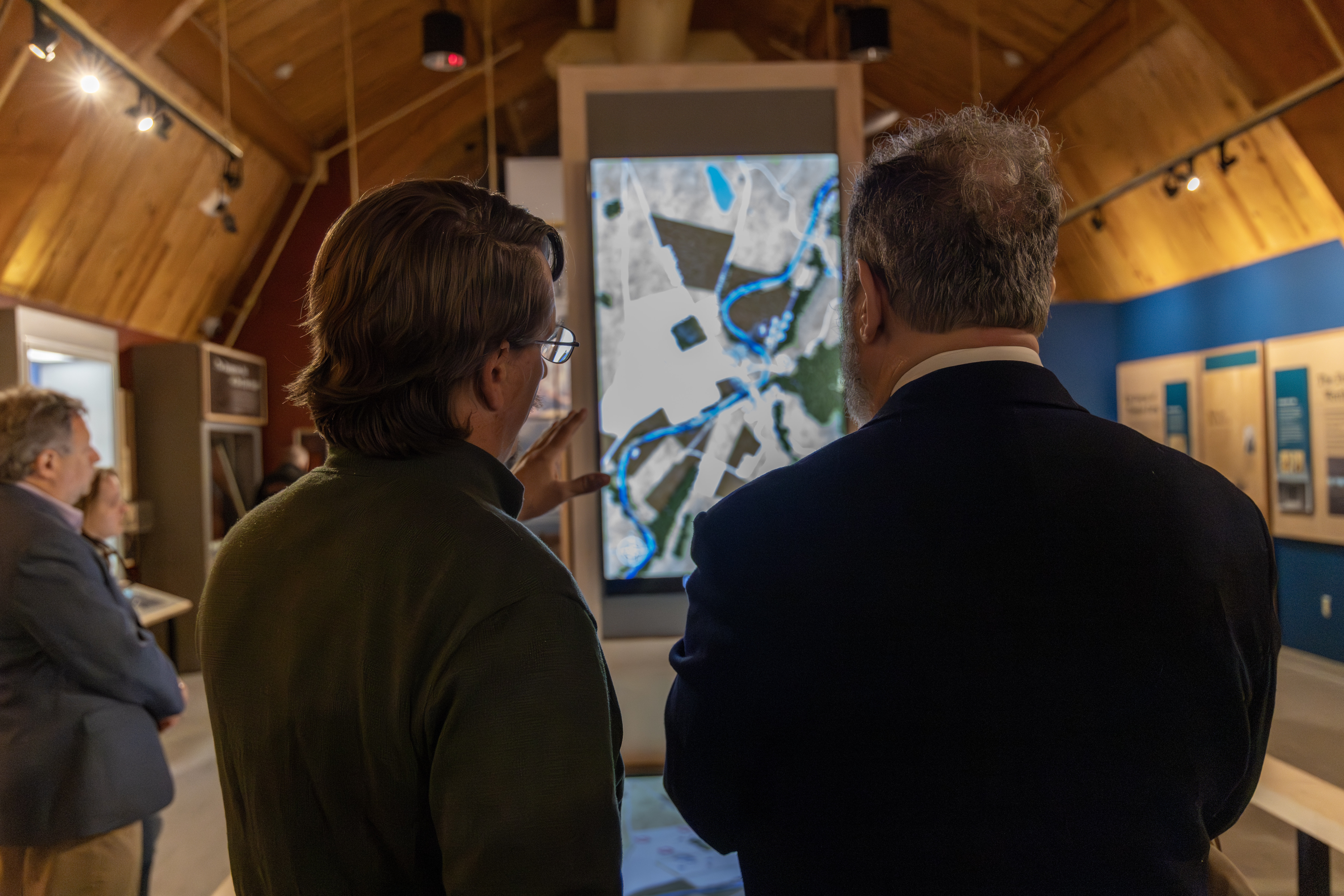 A park ranger talks to a visitor about a museum exhibit.