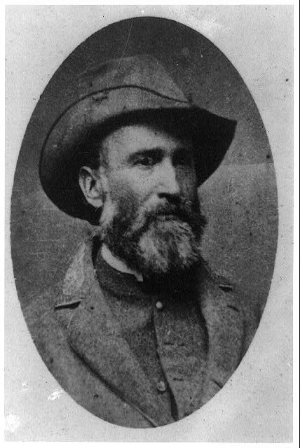 Man with salt and pepper colored beard wearing a Confederate uniform.