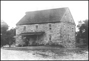 A three-story stone building.