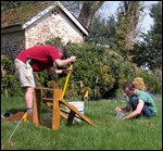 Archeologists digging survey test pits.