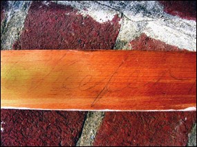 The name Keefer written in pencil on a piece of wood.