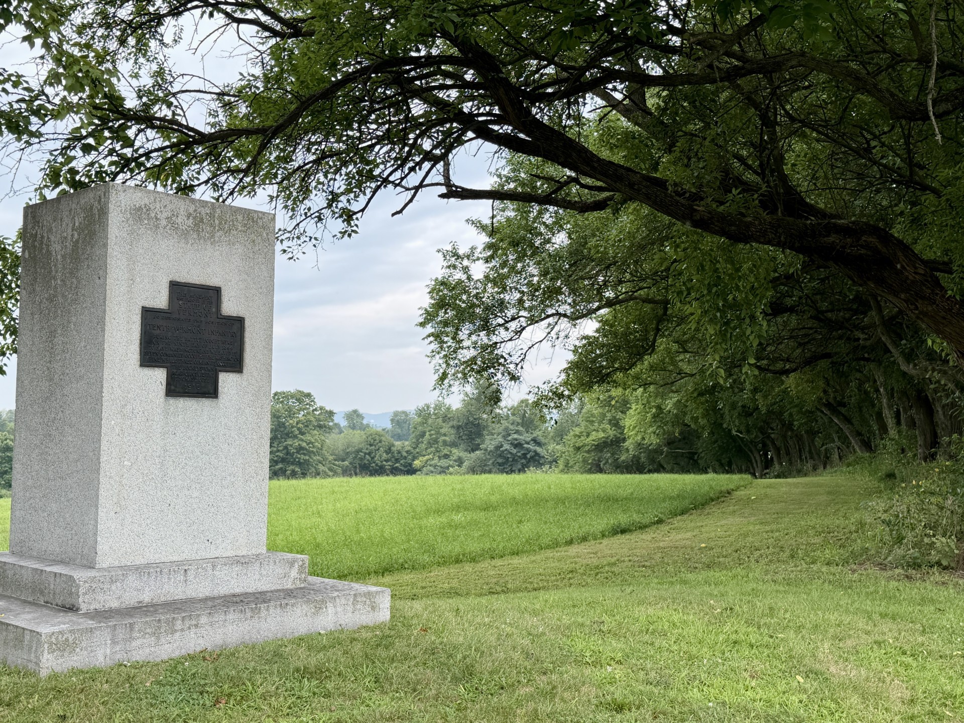A stone monument in front of a grass field at Monocacy National Battlefield.