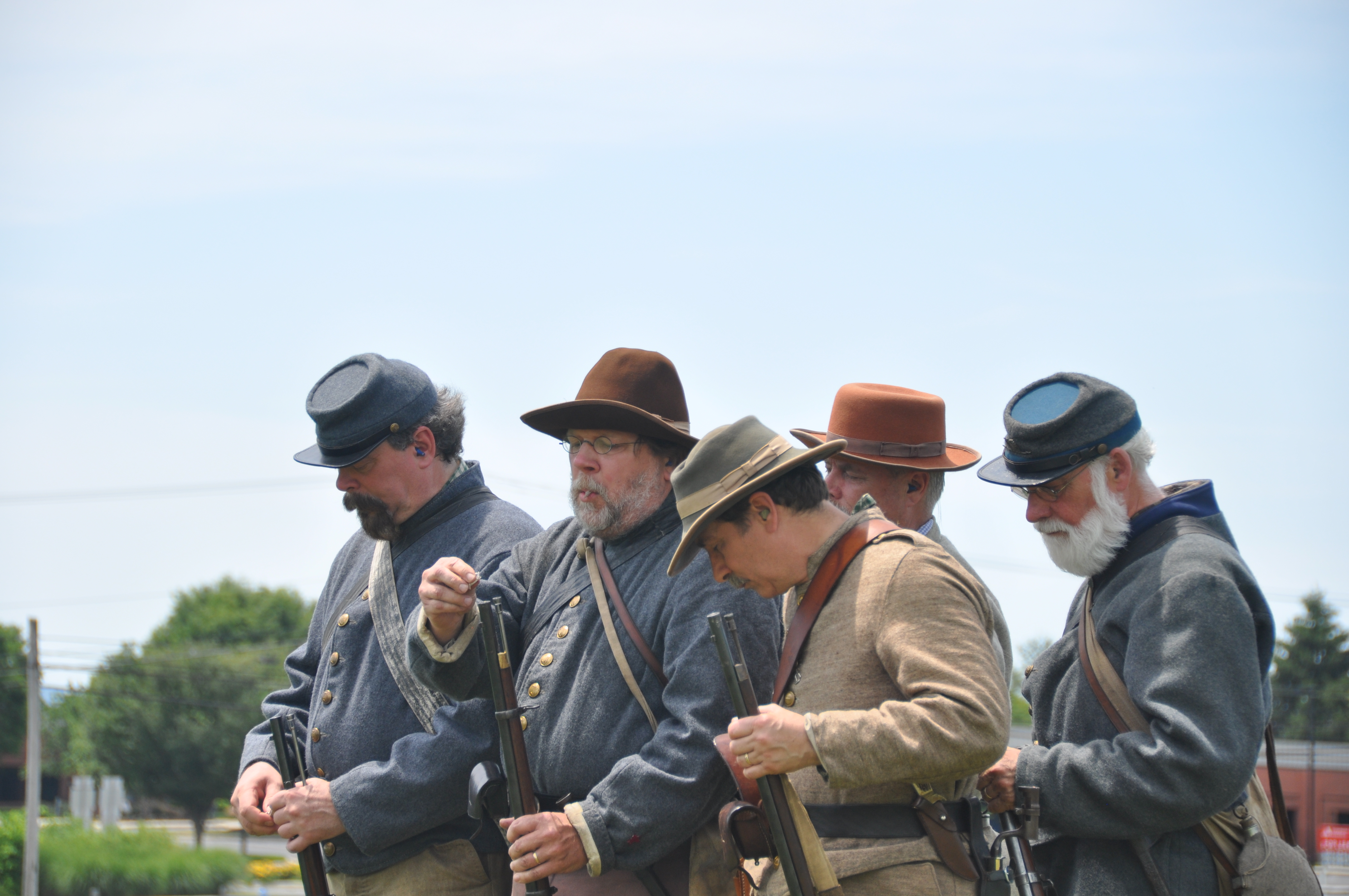 Five men in Confederate uniforms stand in a row.