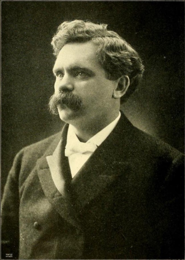 Brigham Henry Roberts Black and white photo of Brigham Henry Roberts. Young man with light-colored eyes, parted, wavy hair, and thick, drooping mustache; wearing a suit jacket and white shirt.