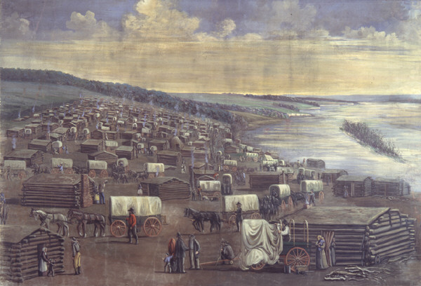 A painting of many small wooden cabins, and covered wagons, along the bank of the river in the winter.