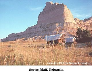 Photo image of Scotts bluff and emigrant wagons.
