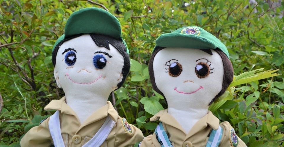 Meadow Rover puppets pose in the bushes.