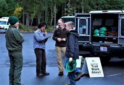 Ranger and volunteer coordinator sign up a youth volunteer.