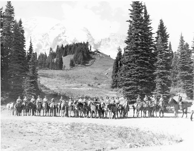 Horseback riding at Paradise A group of people and guides mounted on horseback at Paradise.