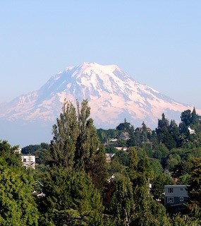 A view of Mount Rainier from Tacoma, WA with houses in the foreground. A view of Mount Rainier from Tacoma, WA with houses in the foreground.