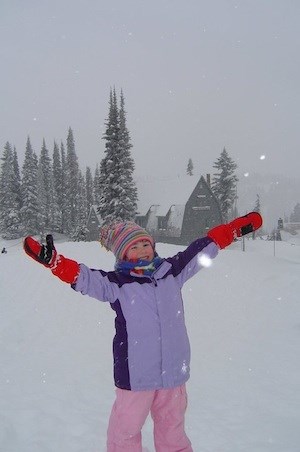 A kid playing in the snow.
