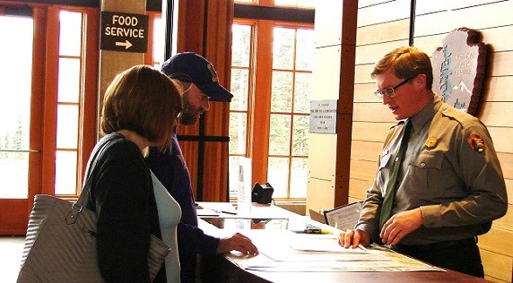 Ranger in the Jackson Visitor Center at Paradise is helping some visitors with advice on good places to hike and view the glaciers.
