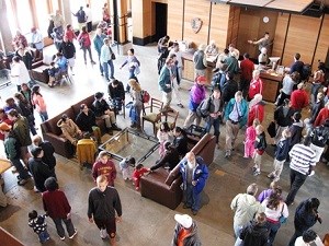 Looking down from the second floor of the Jackson Visitor Center at a large number of people in the lobby .