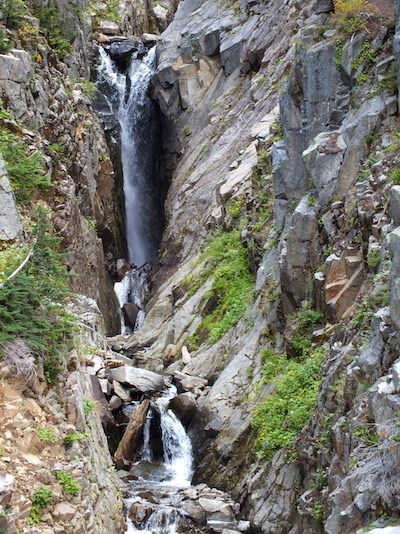 A narrow waterfall in a narrow rocky gorge.