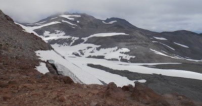 Large patches of stagnant ice and rocky debris in between rock ridges.