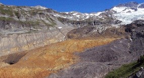 A rock fall on the toe of Tahoma Glacier at Mount Rainier containing hydrothermally altered rock that has oxidized to a yellow-red color.