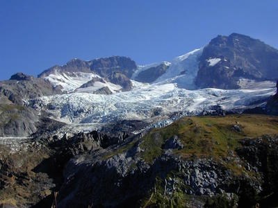 Tahoma Glacier descending from the rocky summit of Mount Rainier.