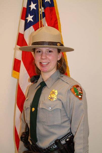 Park Ranger Margaret Anderson in her formal uniform in front of the American flag. Park Ranger Margaret Anderson in her formal uniform in front of the American flag.