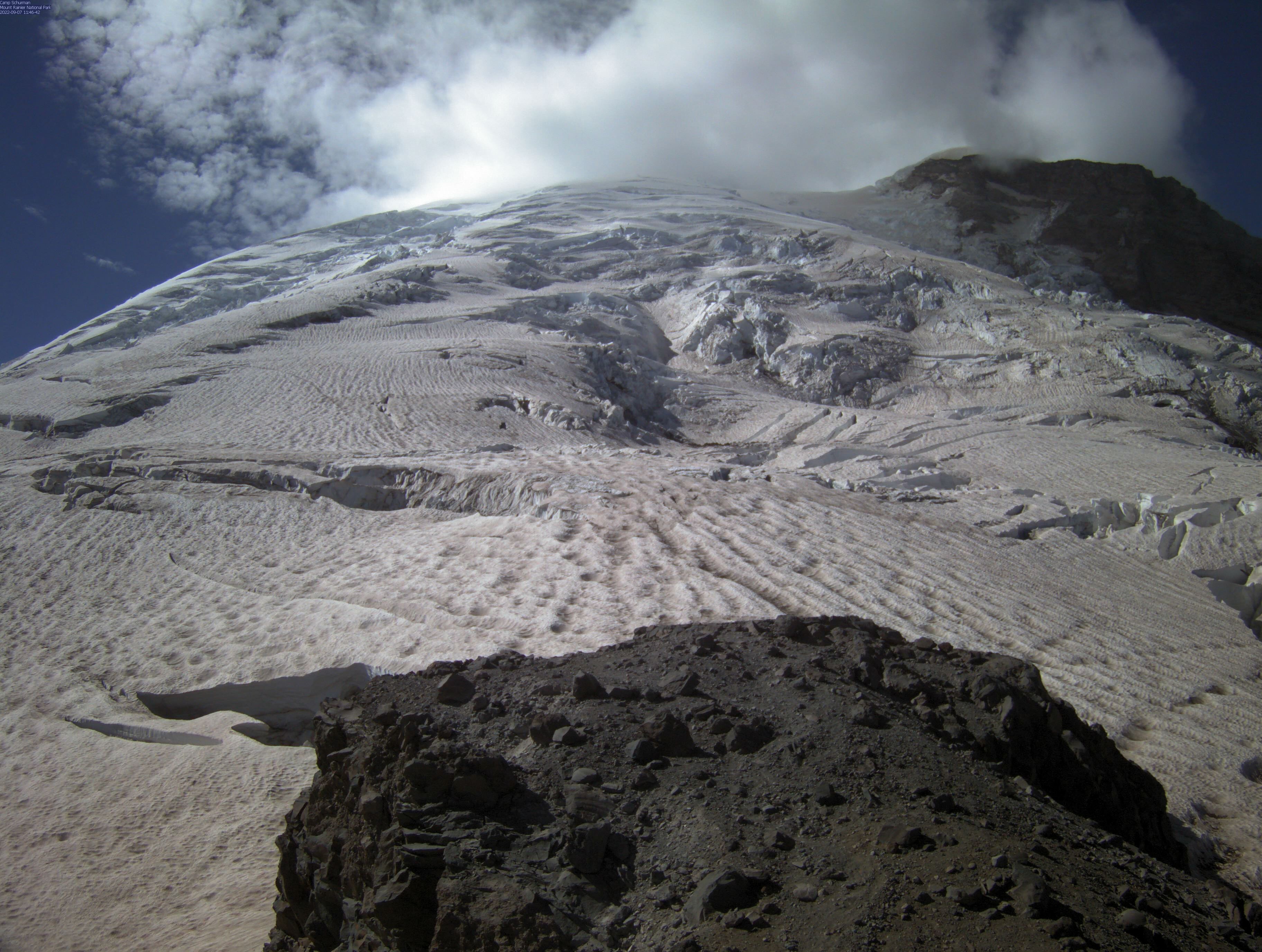 An icy mount slope with a cloud formation above.