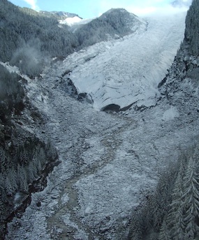 Aerial view of Carbon Glacier and the start of the Carbon River, covered in a dusting of snow.