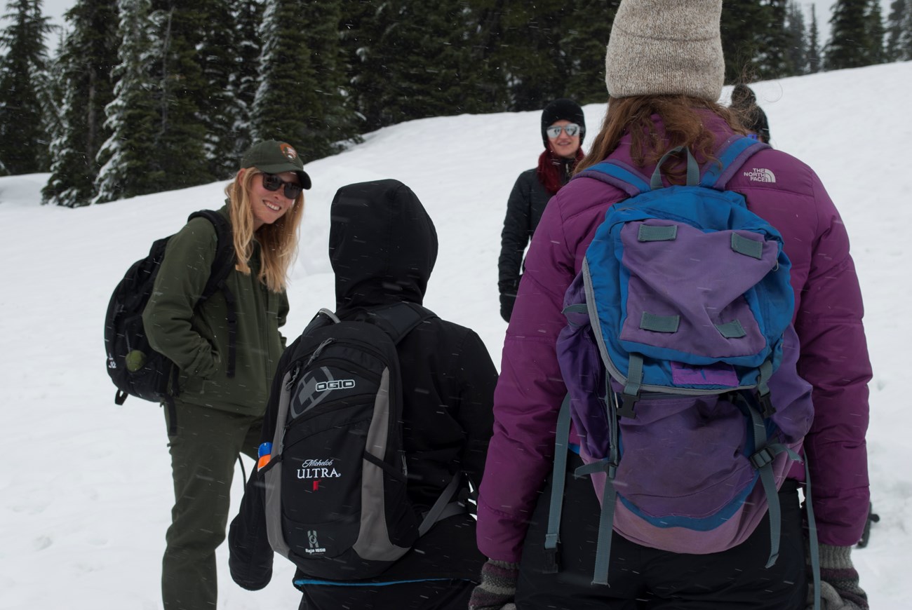 A ranger gets a group of millennials ready to snowshoe at the Mountain Meetup.