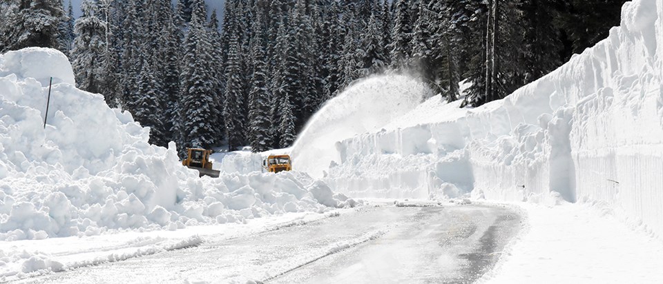 Two plows remove snow on partially snow covered road. Two plows remove snow on partially snow covered road.
