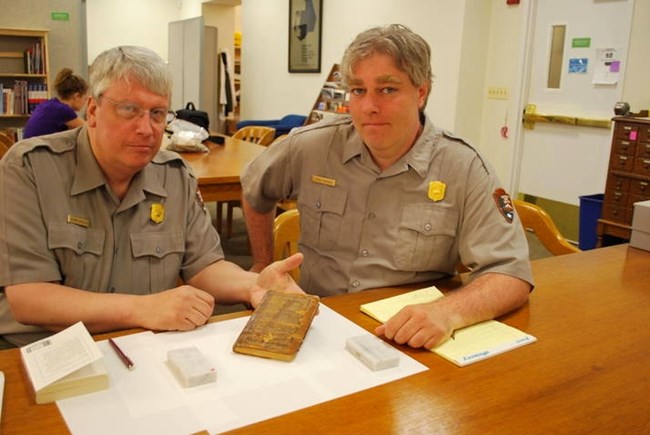Park Ranger Tom Winslow and Teacher-Ranger-Teacher Steve Santucci examining a very unique original copy if Joseph Plum Martin's book based on his time during the American Revolution