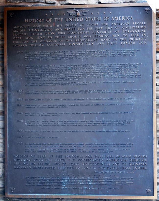 Photo of a bronze plaque inscribed with the winning essay.