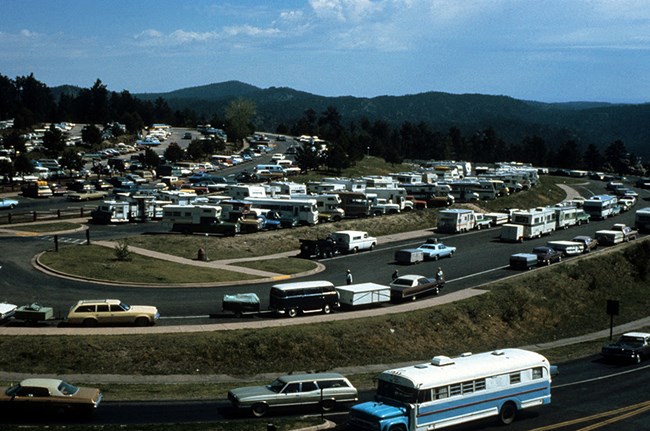 View of the parking lot curing the 1960's nearly filled to capacity.  Highway 244 is at the bottom of the image, with five tiers of levels of the parking lot moving from lower right to upper left.