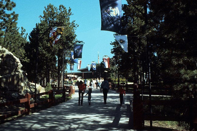 Walkway from the parking lot to the Visitor Center as it looked after the state flags were added for the Bicentennial Celebration in 1976. Walkway from the parking lot to the Visitor Center as it looked after the state flags were added for the Bicentennial Celebration in 1976.