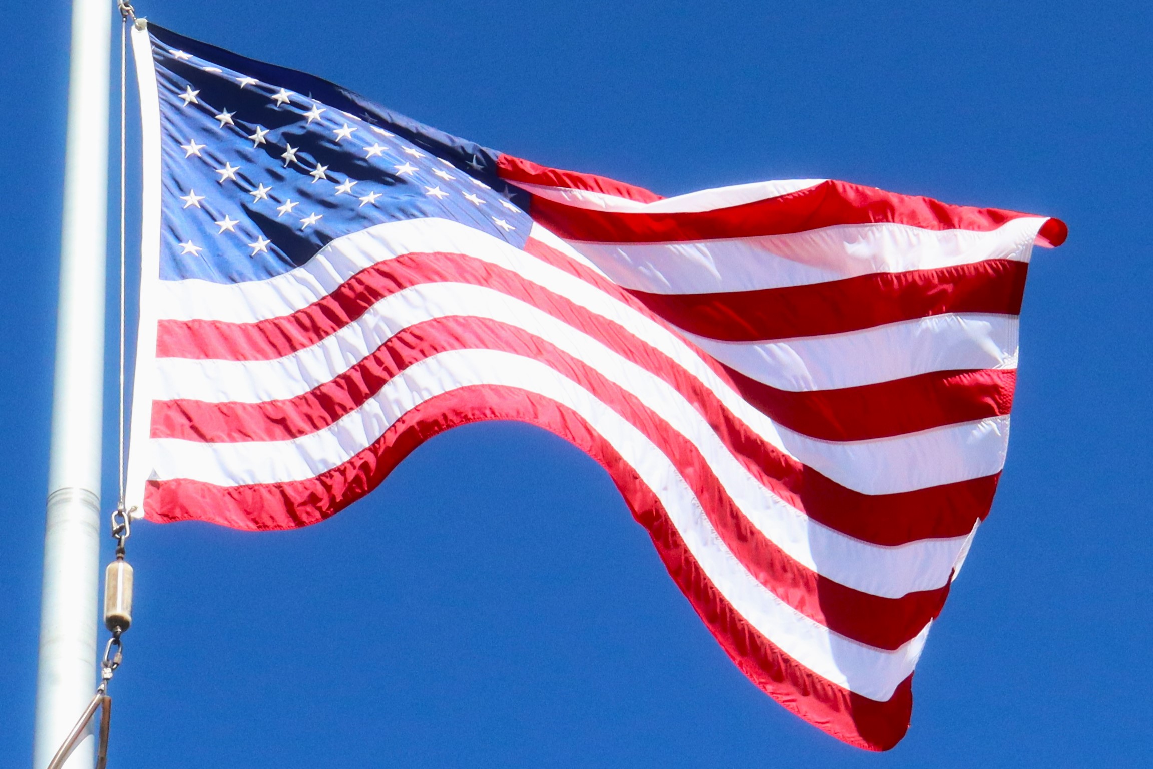 Red, white, and blue flag blowing in the wind.