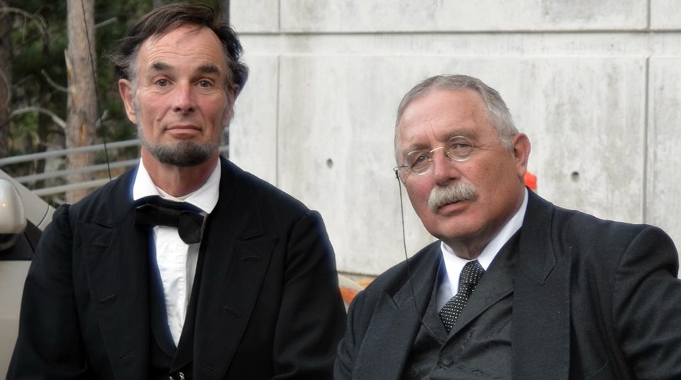 Abraham Lincoln reenactor Fritz Klein (left) seated next to Theodore Roosevelt reenactor Gib Young (right) at Mount Rushmore. Abraham Lincoln reenactor Fritz Klein (left) seated next to Theodore Roosevelt reenactor Gib Young (right) at Mount Rushmore.