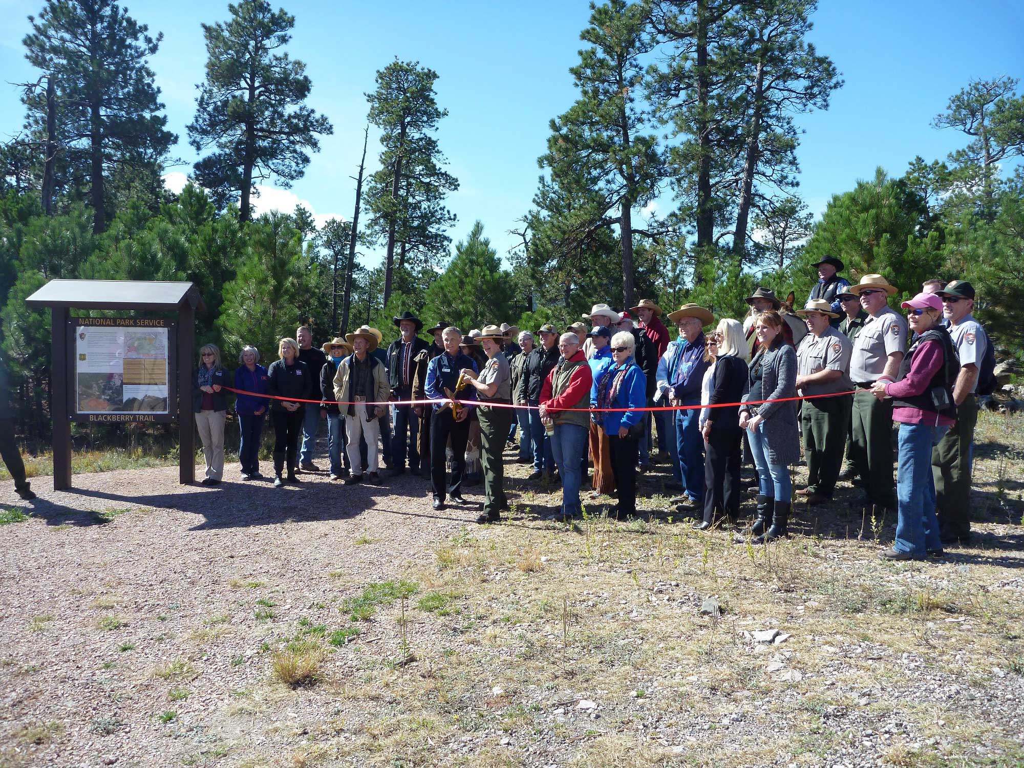 Superintendent Cheryl A. Schreier and President of the Mount Rushmore Society Tim Raben cut the ribbon on the Blackberry Trail.