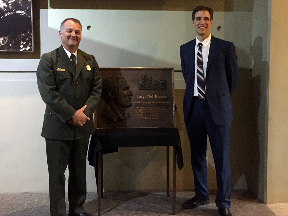 Cam Sholly, National Park Service Regional Director, and Lou Del Bianco, Grandson of Luigi Del Bianco, with new plaque honoring the Chief Carver. Cam Sholly, National Park Service Regional Director, and Lou Del Bianco, Grandson of Luigi Del Bianco, with new plaque honoring the Chief Carver.