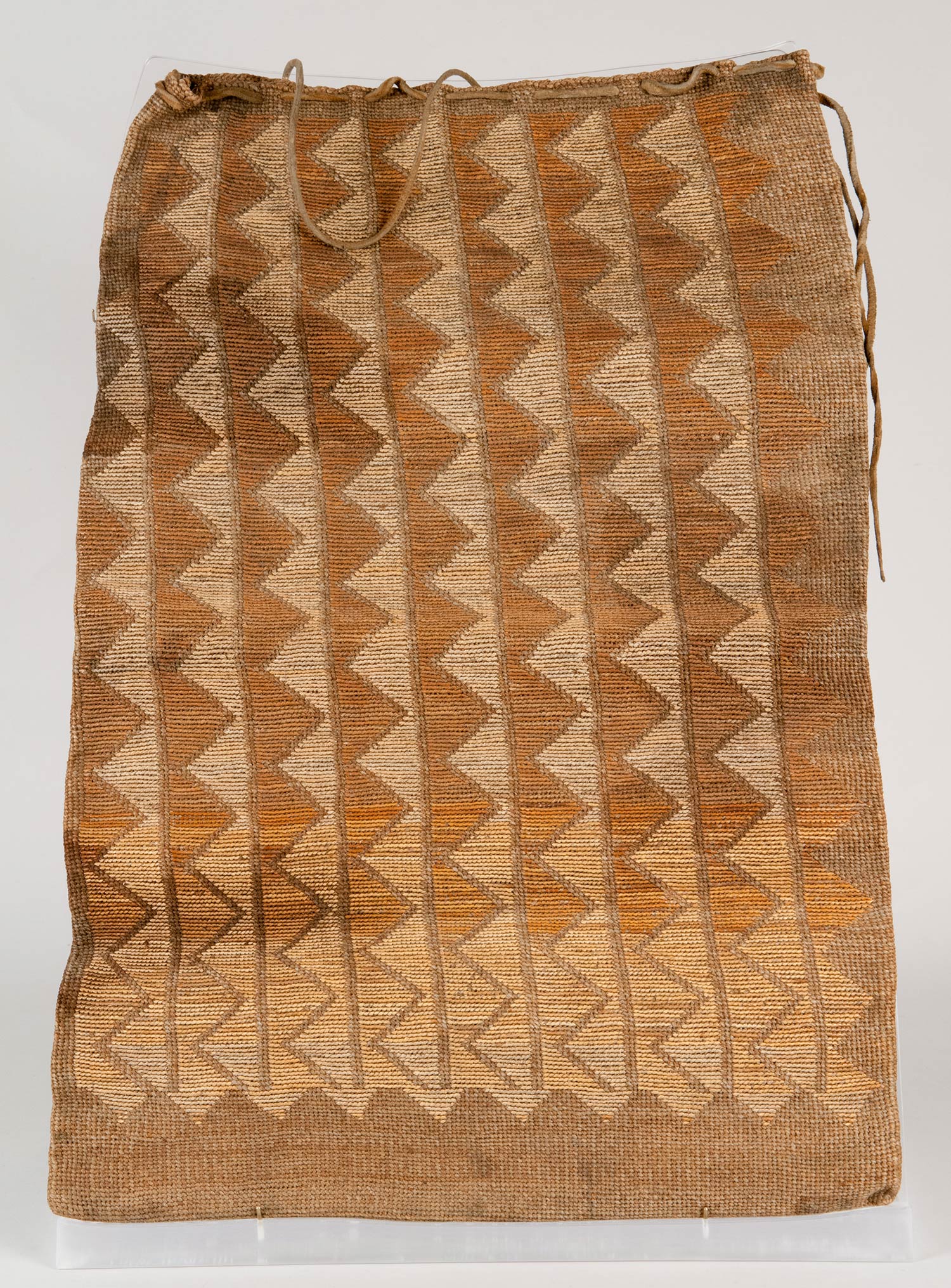 Vertically woven, Large, flat cornhusk bag. Constructed using plain twining of Indian hemp with dyed and undyed cornhusk false embroidery. Geometric hourglass figures featured on both sides.