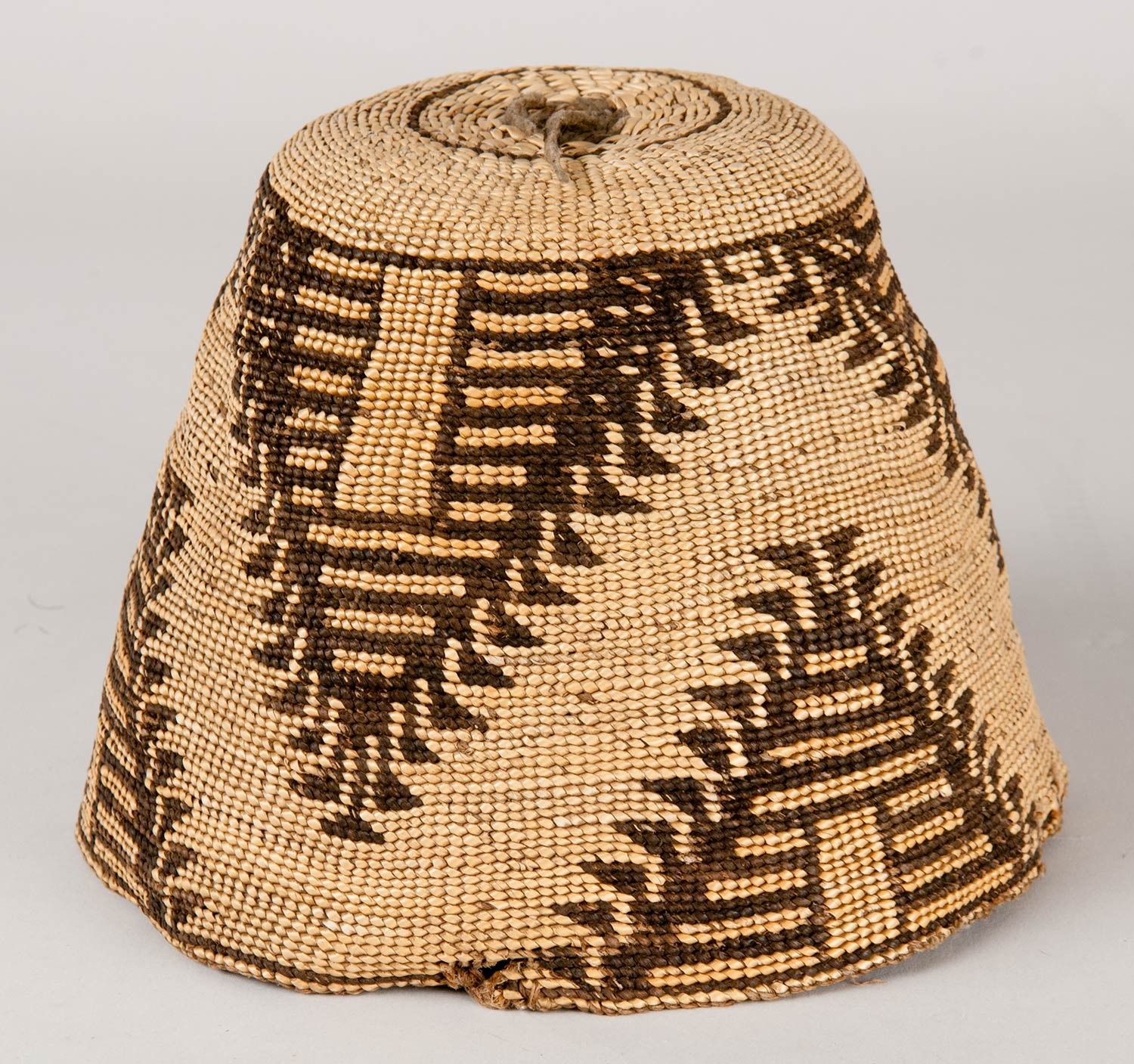Subconical shaped basket hat made from hemp and beargrass. Designs on the hat feature a three part separated pyramid with horizontal banding on the interior in orange and dark brown.