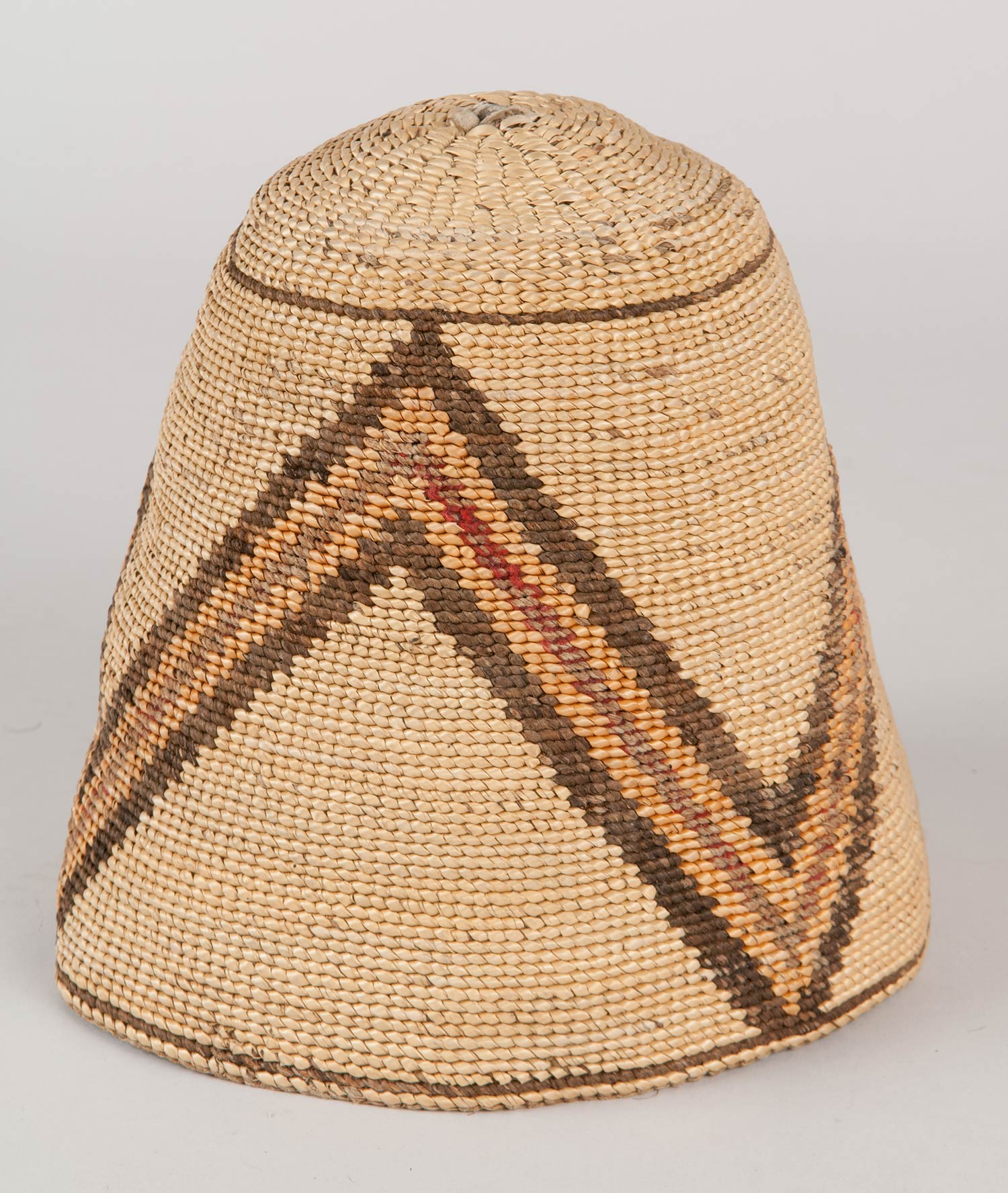 Subconical shaped basket hat made from hemp and beargrass. Designs on the hat feature a three part separated pyramid with horizontal banding on the interior in orange and dark brown.