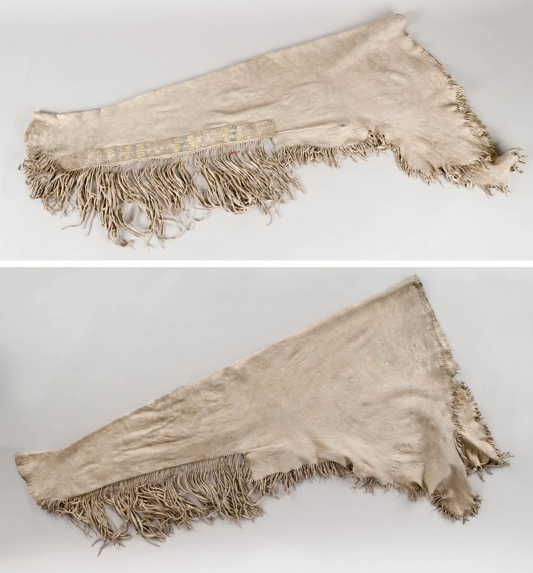 Pair of men's leggings made from cured unsmoked deerskin with porcupine quill decorated side panels and fringe decorations.