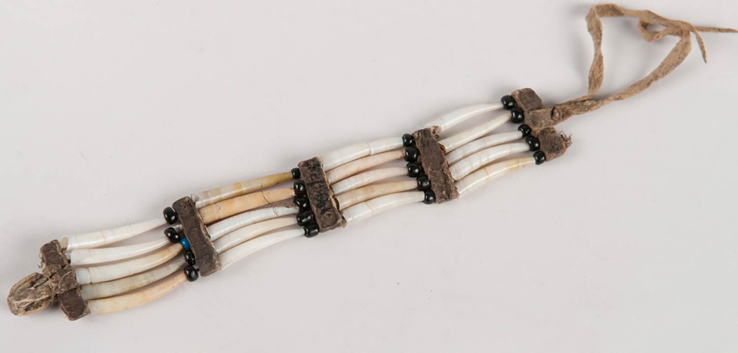 Dentalia shell and glass bead bracelet. Bison hide leather used as spacers and painted in vermillion ochre.