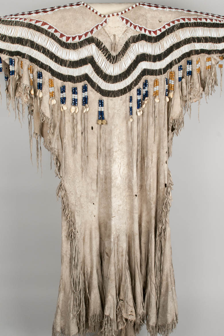 Woman's dress made of two deer skins and decorated with glass beads, dentalium, thimbles, elk teeth, and fringe. 