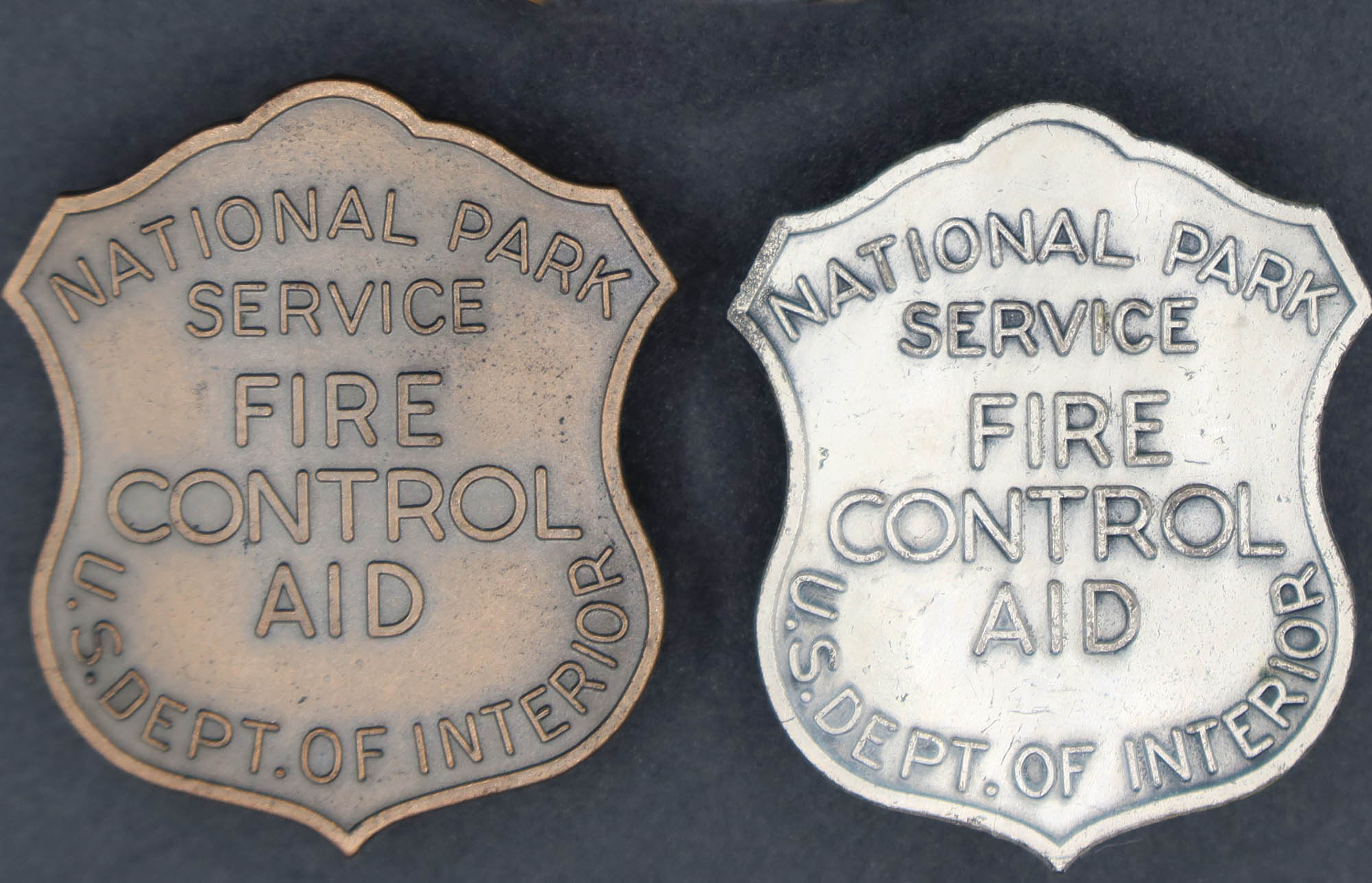 Shield-shaped badges marked, National Park Service and US Depart of Interior. One marked Fire Guard and 179. Two marked Fire Control Aid.