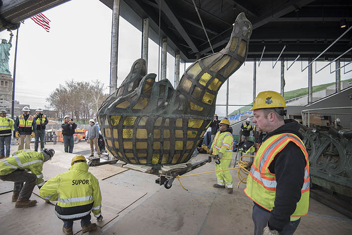 Workers moving the Statue of Liberty's Torch into new museum 

