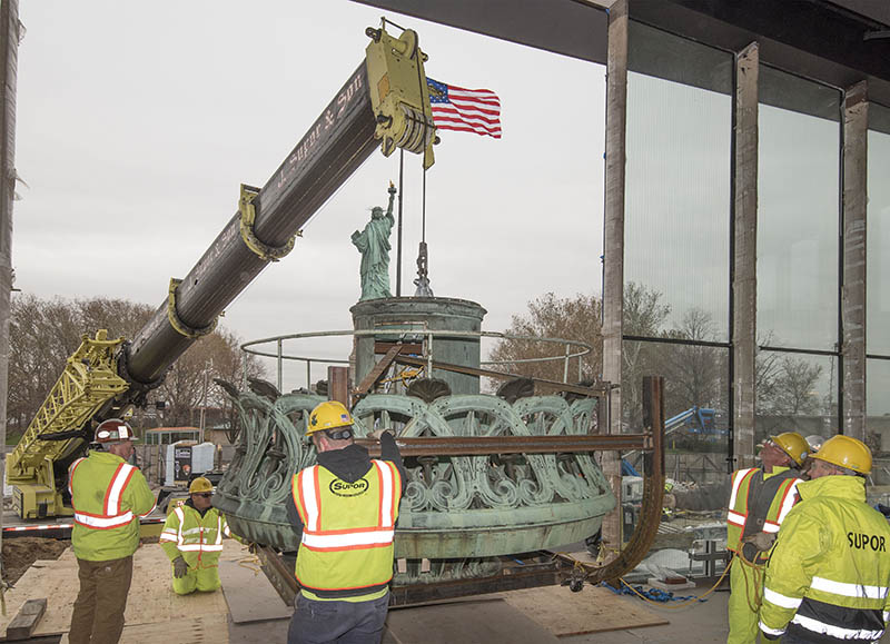Workers moving the Statue of Liberty's Torch base into new museum 

