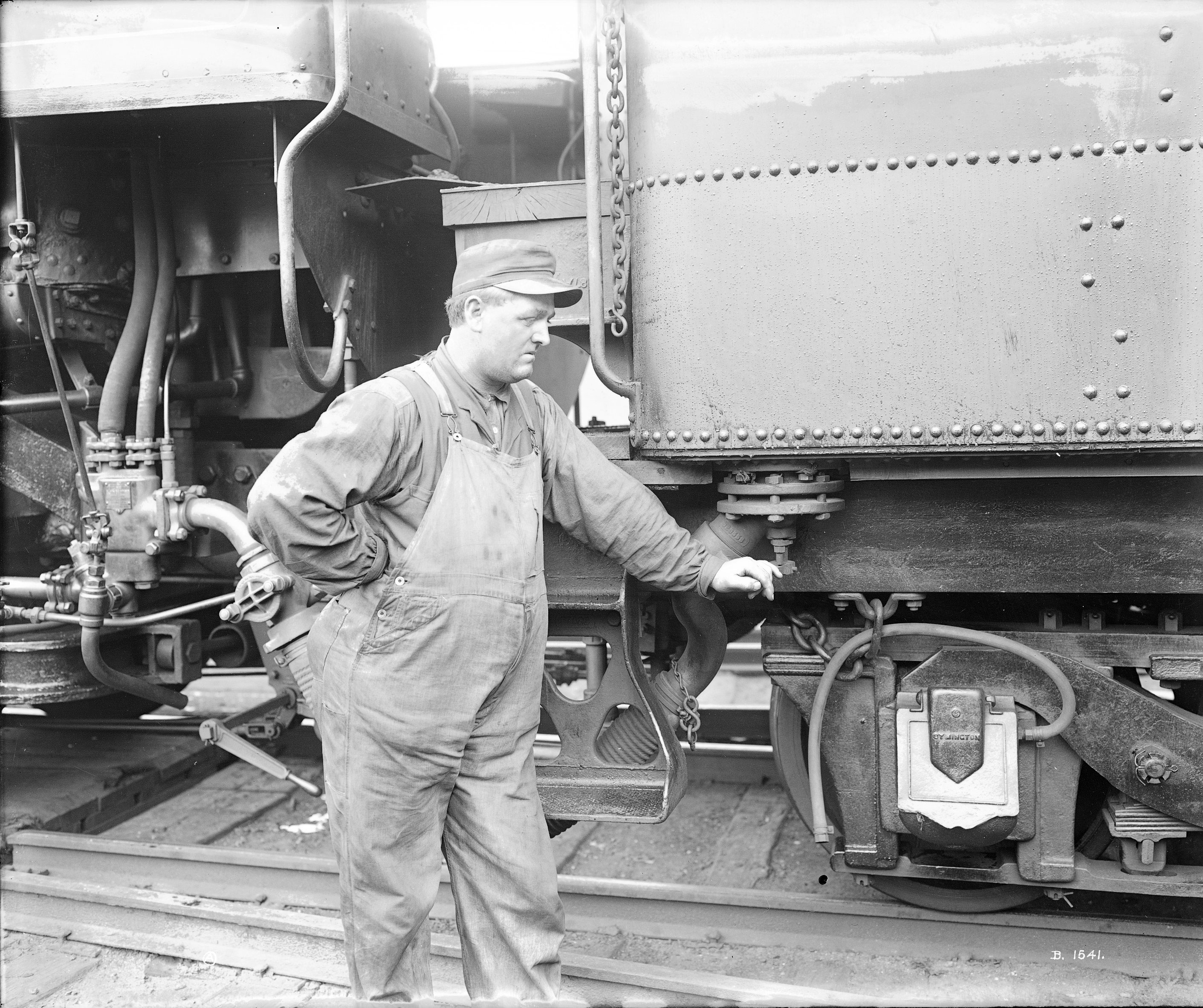 Railyard engineer next to locomotive