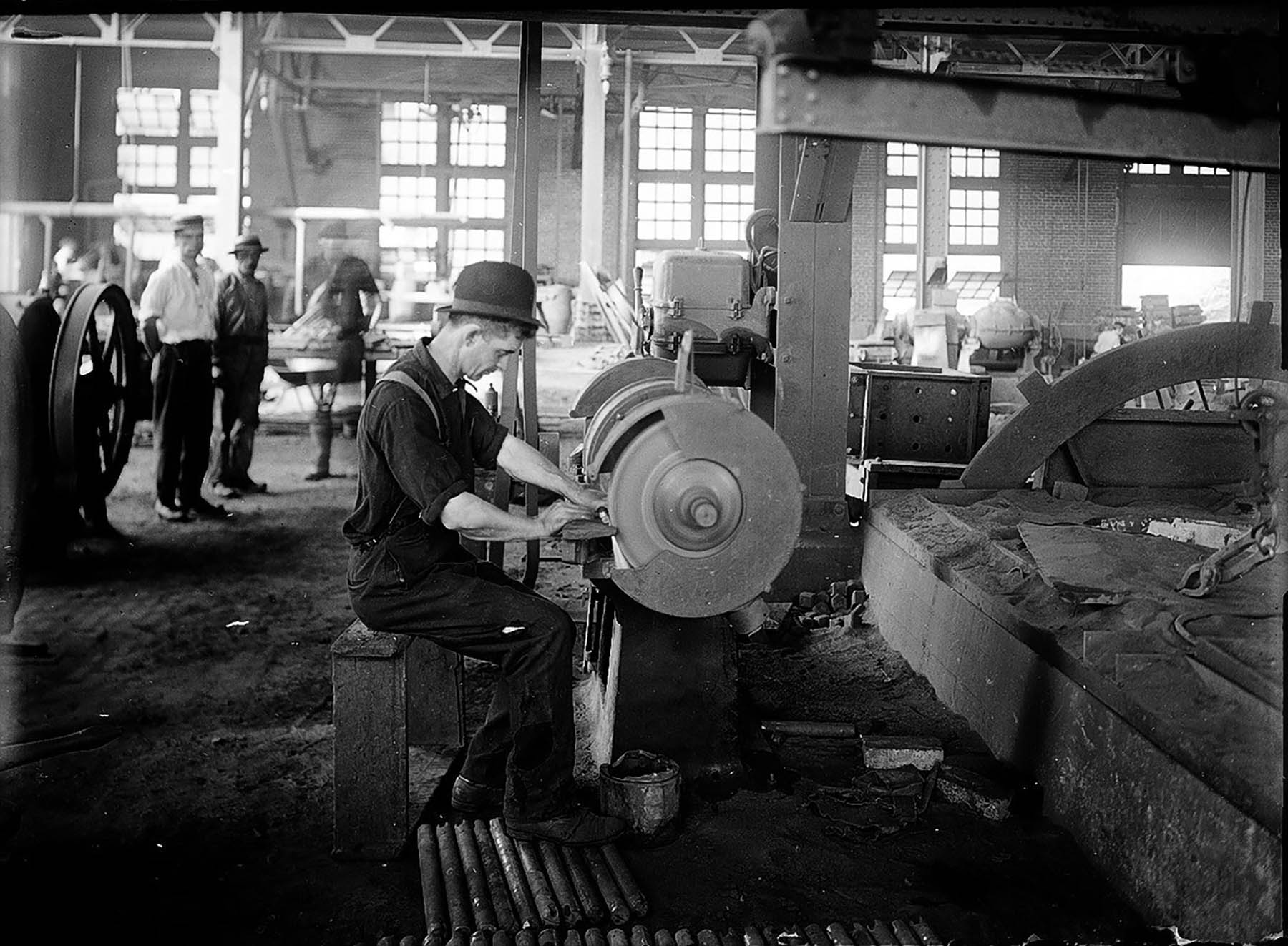 Using a grinder in Delaware, Lackawanna, & Western Railroad locomotive sho